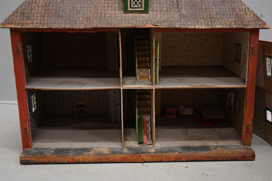 A 1920s/30s commercially produced dolls house, possibly by Tri-ang, of plywood construction, overlaid with printed paper roof tiles and brickwork, and tinplate windows and window frames, comprising of four rooms with bay